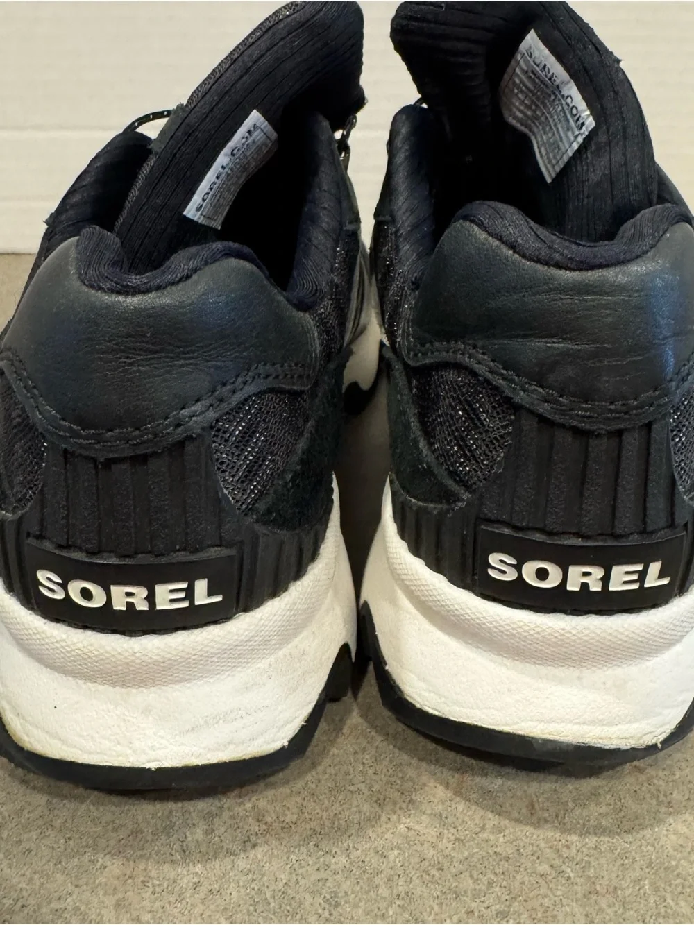 Sorel Women’s Kinetic Speed Black and White Wave-Soled Slip-On Sneakers